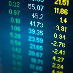 A picture of an abstract financial trading graphs and digital number on monitor meant to represent stock market trend. Colour of the text are gold and blue digital.
